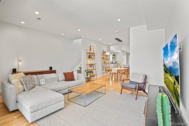 living area with recessed lighting, stairway, visible vents, and light wood finished floors