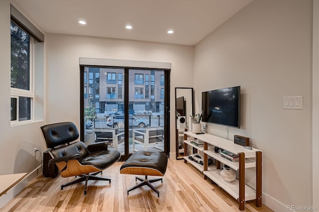 sitting room with recessed lighting, baseboards, and wood finished floors