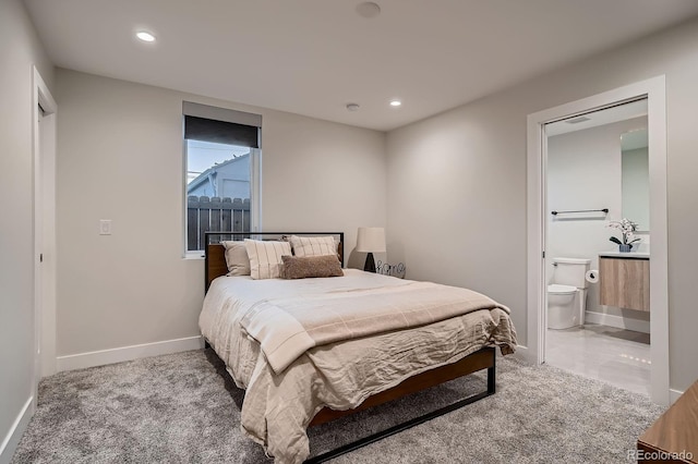 bedroom with recessed lighting, baseboards, and ensuite bathroom