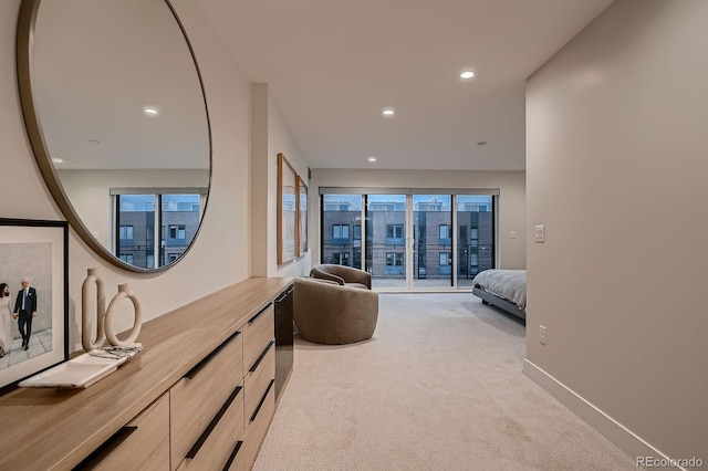 bedroom with recessed lighting, light colored carpet, baseboards, and access to outside