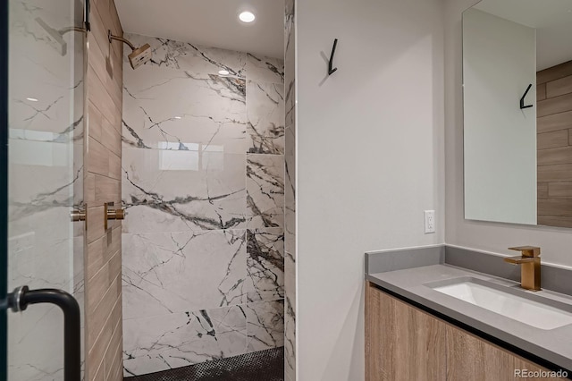 bathroom with a marble finish shower and vanity