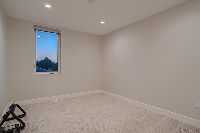 unfurnished room featuring visible vents, recessed lighting, baseboards, and carpet