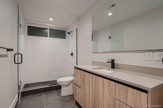 bathroom with visible vents, vanity, toilet, and a shower stall