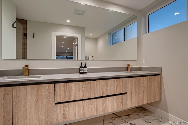 3232 W 16th Ave, Denver, CO 80204 - bathroom featuring marble look tiles, double vanity, recessed lighting, and baseboards