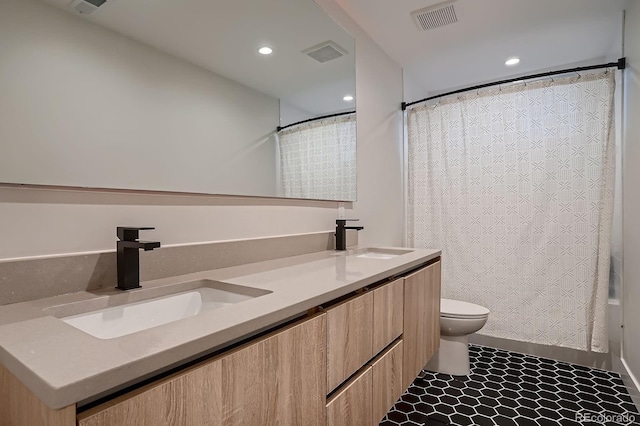 3232 W 16th Ave, Denver, CO 80204 - bathroom with toilet, double vanity, recessed lighting, and a shower with shower curtain