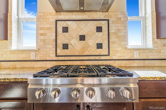 7172 S Oakleaf St, Bennett, CO 80102 - kitchen with a healthy amount of sunlight, stainless steel gas stovetop, backsplash, and light stone counters