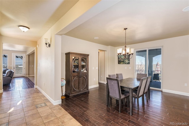 7172 S Oakleaf St, Bennett, CO 80102 - dining area with baseboards, a notable chandelier, and wood finished floors