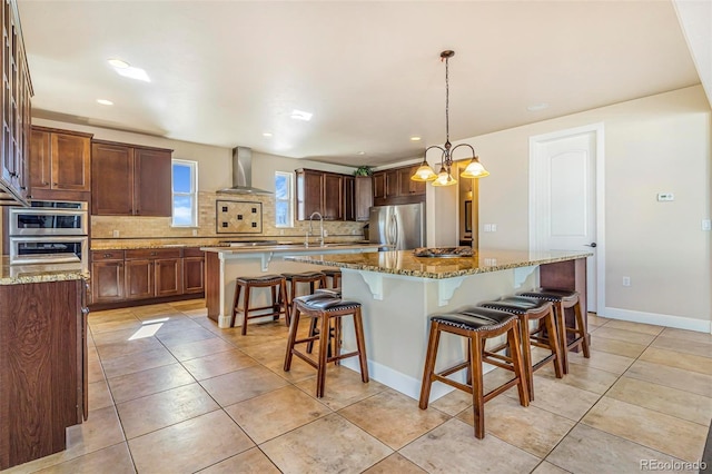 7172 S Oakleaf St, Bennett, CO 80102 - kitchen featuring decorative backsplash, a kitchen island, wall chimney exhaust hood, and stainless steel appliances