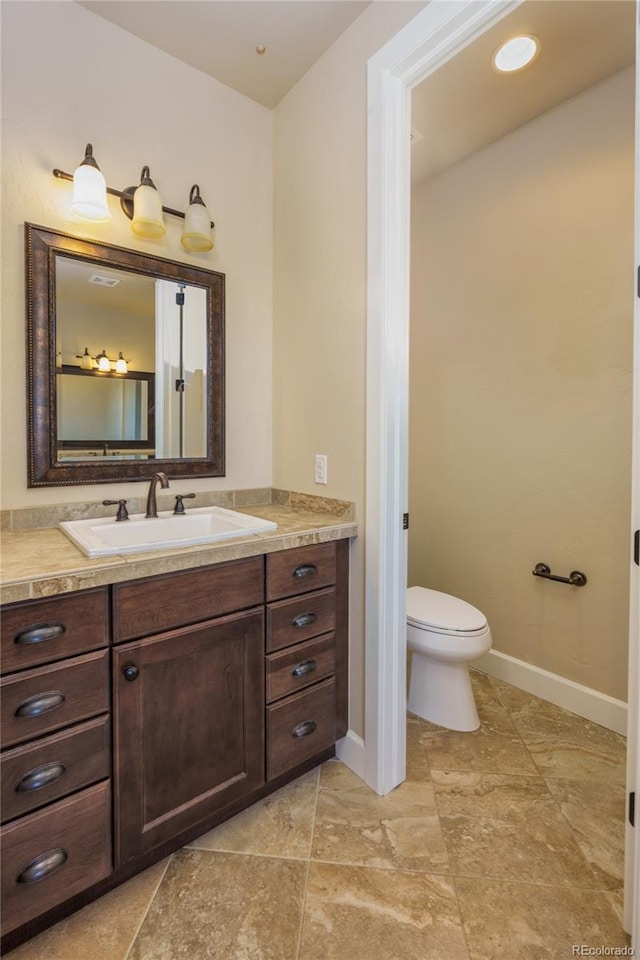 7172 S Oakleaf St, Bennett, CO 80102 - bathroom featuring baseboards, vanity, and toilet