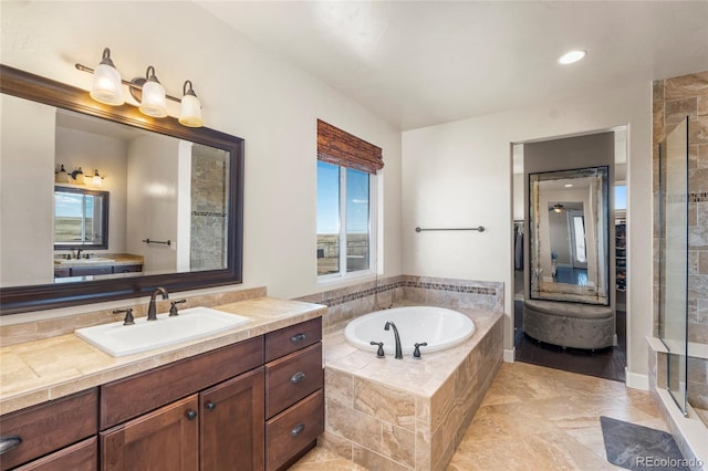 7172 S Oakleaf St, Bennett, CO 80102 - bathroom featuring plenty of natural light, a garden tub, vanity, and a stall shower