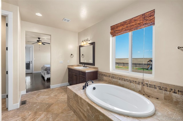 7172 S Oakleaf St, Bennett, CO 80102 - bathroom with vanity, baseboards, visible vents, a bath, and ceiling fan