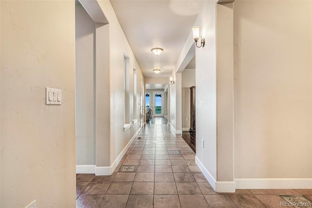7172 S Oakleaf St, Bennett, CO 80102 - corridor featuring tile patterned floors and baseboards