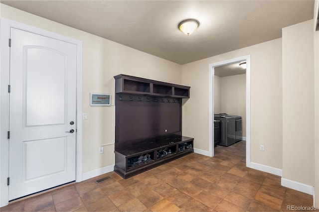 7172 S Oakleaf St, Bennett, CO 80102 - mudroom featuring baseboards, stone finish flooring, washer and dryer, and visible vents