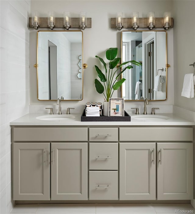 bathroom with tile walls, double vanity, and tile flooring