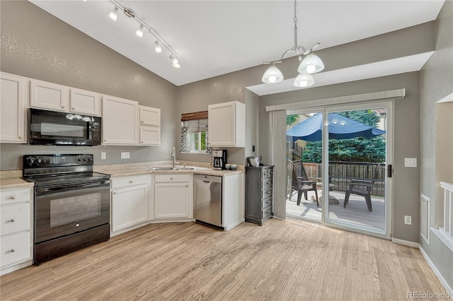 21789 Farmingdale Way, Parker, CO 80138 - kitchen with black appliances, light wood-style floors, white cabinetry, light countertops, and lofted ceiling
