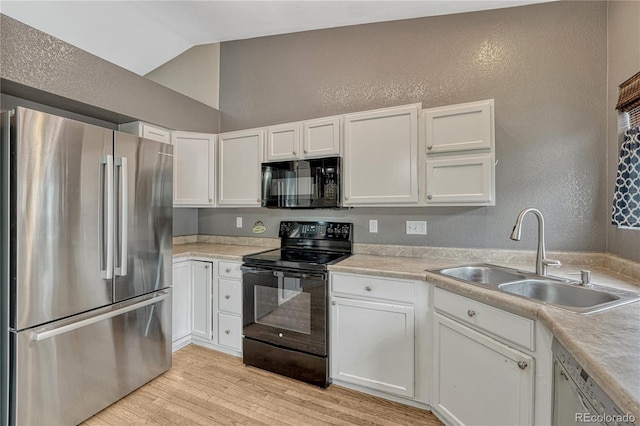 21789 Farmingdale Way, Parker, CO 80138 - kitchen with black appliances, a textured wall, vaulted ceiling, white cabinets, and light wood finished floors