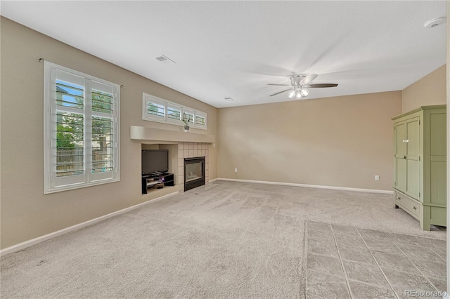 21789 Farmingdale Way, Parker, CO 80138 - unfurnished living room with a fireplace, a ceiling fan, and light carpet