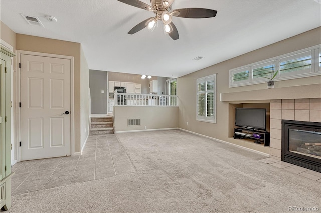 21789 Farmingdale Way, Parker, CO 80138 - unfurnished living room with carpet, a fireplace, tile patterned flooring, and ceiling fan
