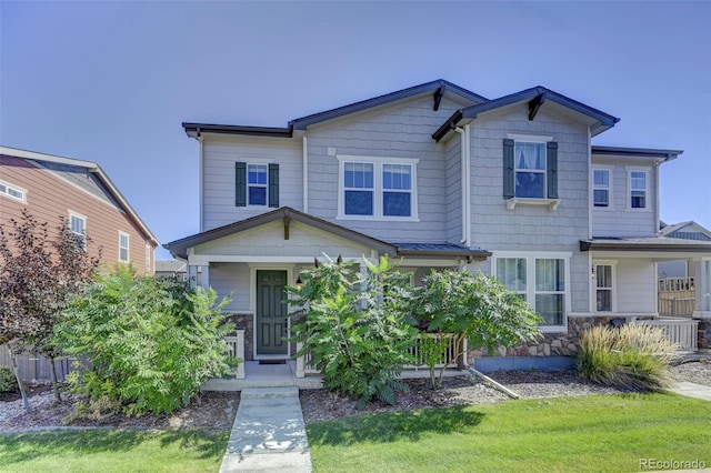 view of front of property with a front yard, a porch, and central AC