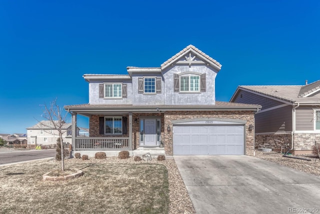 view of front of home with covered porch, concrete driveway, and a tiled roof