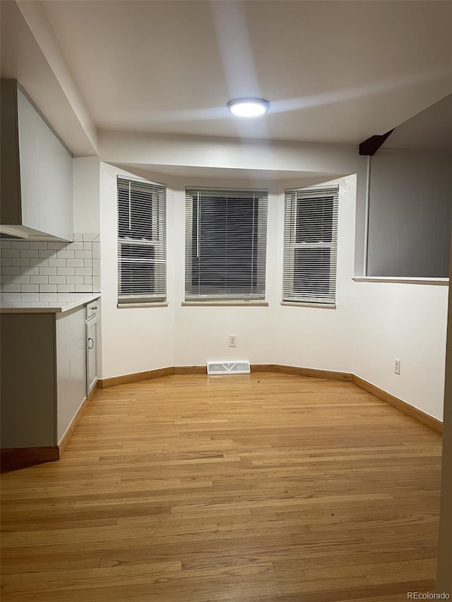 unfurnished dining area featuring light hardwood / wood-style floors