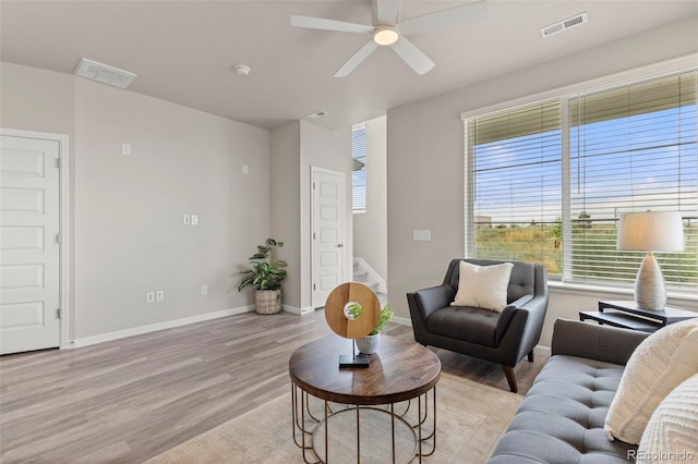9284 Gore St Unit A, Arvada, CO 80007 - living area with light wood-style flooring, stairway, and a ceiling fan
