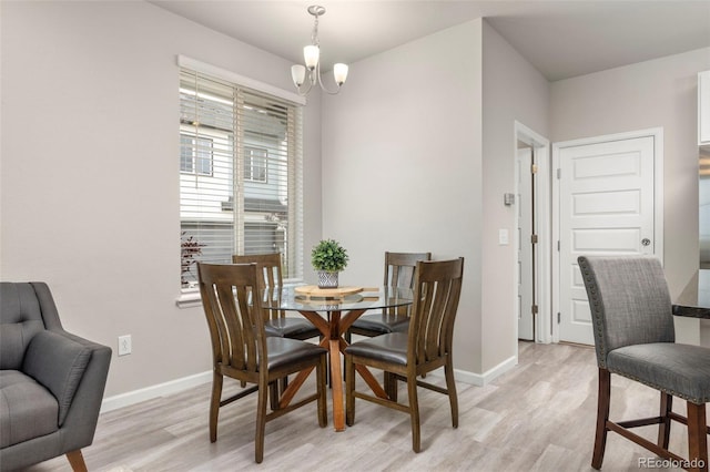 9284 Gore St Unit A, Arvada, CO 80007 - dining area with light wood-style floors and a chandelier