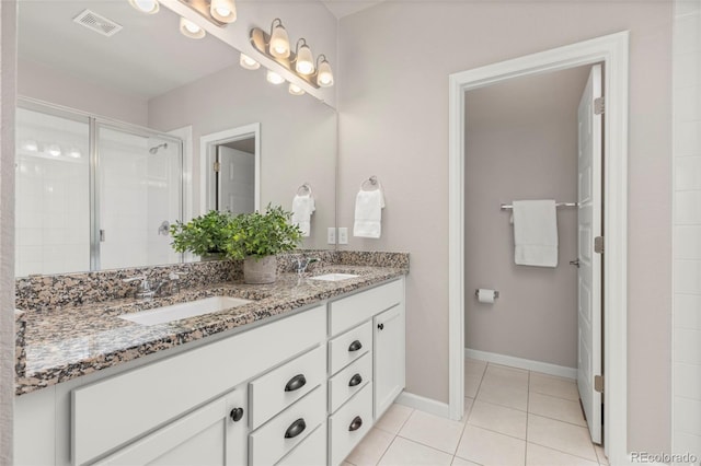 9284 Gore St Unit A, Arvada, CO 80007 - bathroom with double vanity, tile patterned floors, and a stall shower