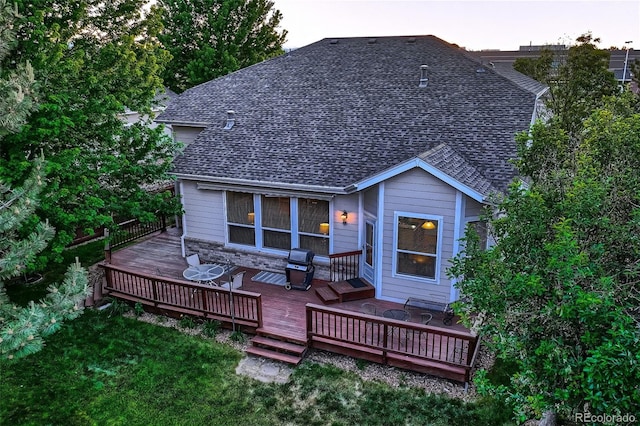 rear view of house with a yard and a wooden deck