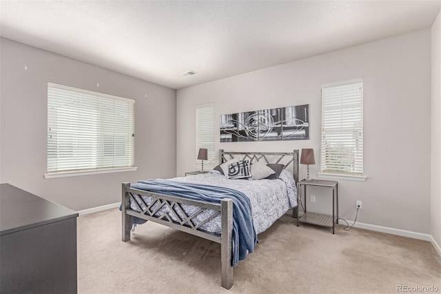 bedroom with carpet flooring and baseboards