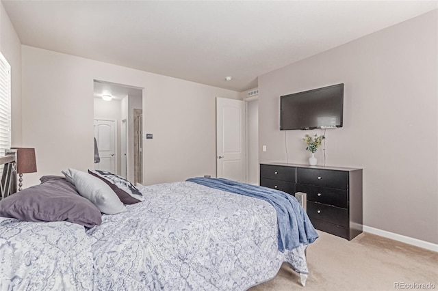 bedroom featuring light colored carpet and baseboards