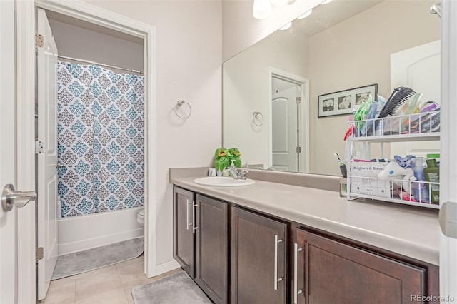 bathroom featuring vanity, tile patterned flooring, toilet, and shower / bath combo with shower curtain