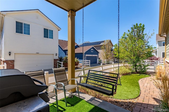 view of patio featuring a garage and a residential view