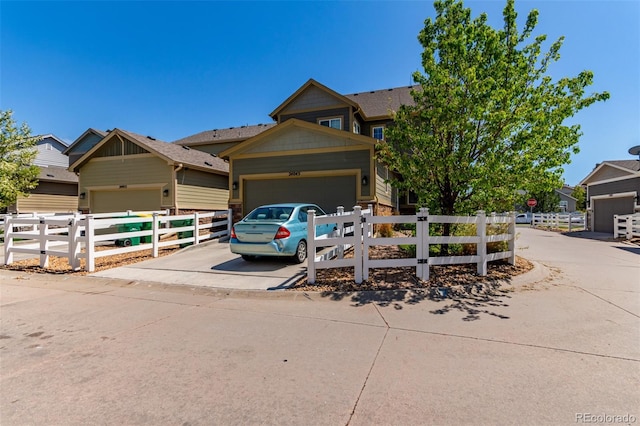 view of property hidden behind natural elements with driveway and a garage