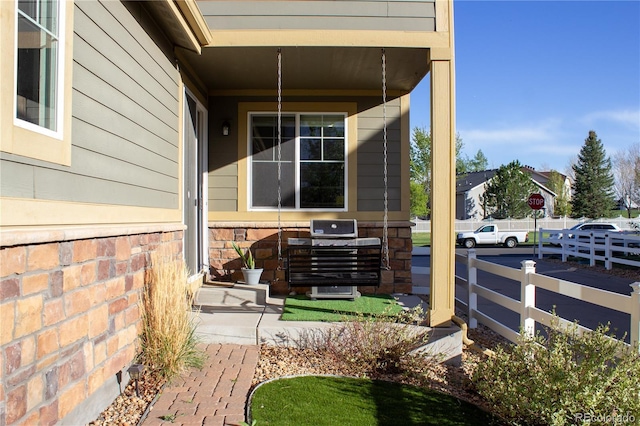 view of side of home featuring fence