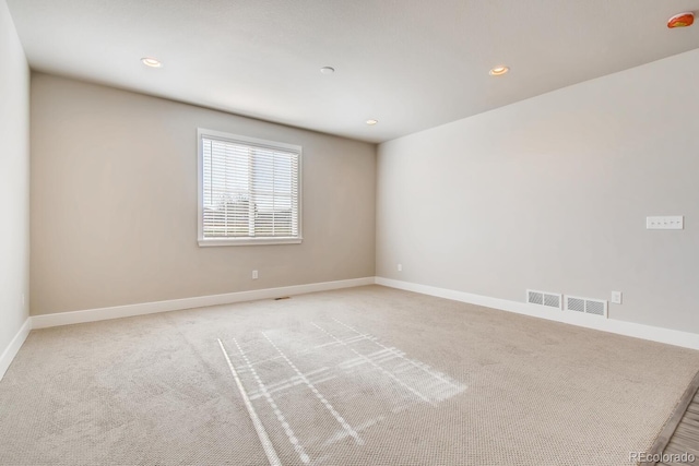 unfurnished room with visible vents, baseboards, recessed lighting, and light colored carpet