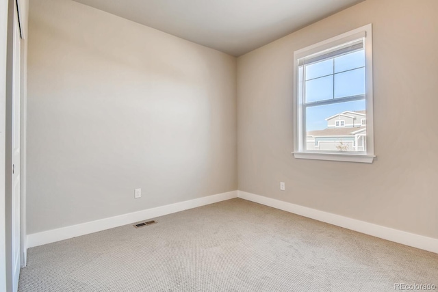 unfurnished room with baseboards, carpet flooring, and visible vents