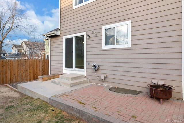 exterior space featuring entry steps, a patio area, and fence