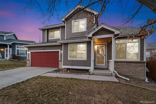 view of front of home with concrete driveway, brick siding, and an attached garage