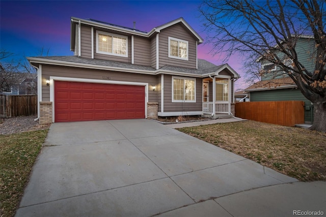 traditional-style home featuring driveway, roof with shingles, an attached garage, fence, and brick siding