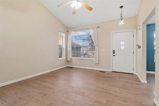 foyer entrance featuring visible vents, light wood-style flooring, and baseboards