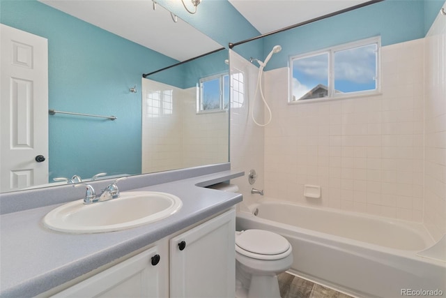 bathroom featuring toilet, vanity, shower / tub combination, and wood finished floors