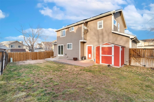 rear view of house featuring entry steps, a patio area, a fenced backyard, and a yard