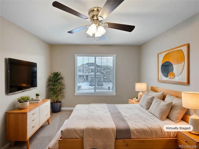 bedroom featuring light carpet and ceiling fan