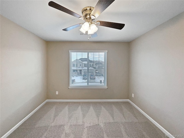 carpeted spare room featuring ceiling fan