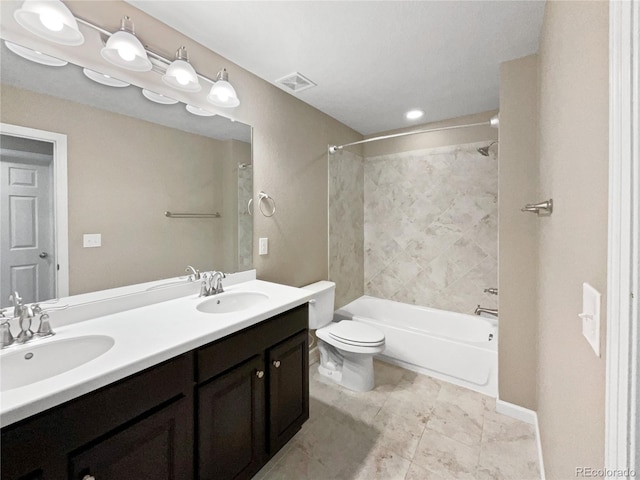 full bathroom with vanity, toilet, and tiled shower / bath