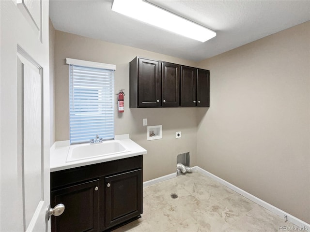 clothes washing area with sink, cabinets, hookup for a washing machine, and hookup for an electric dryer