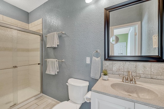 bathroom featuring vanity, toilet, and an enclosed shower