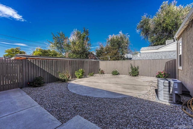 view of yard with a patio and central air condition unit