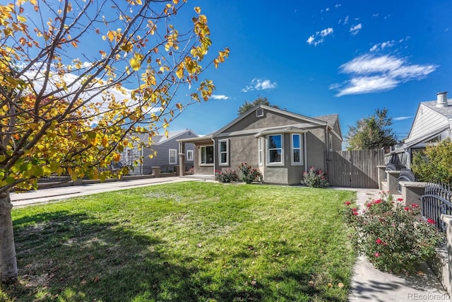 rear view of property featuring a lawn